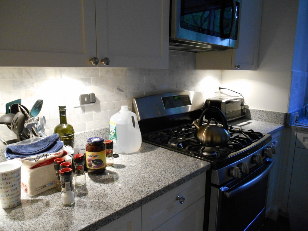 Kitchen counter and stove at Diane and Frank's with the under-cabinet lighting turned on