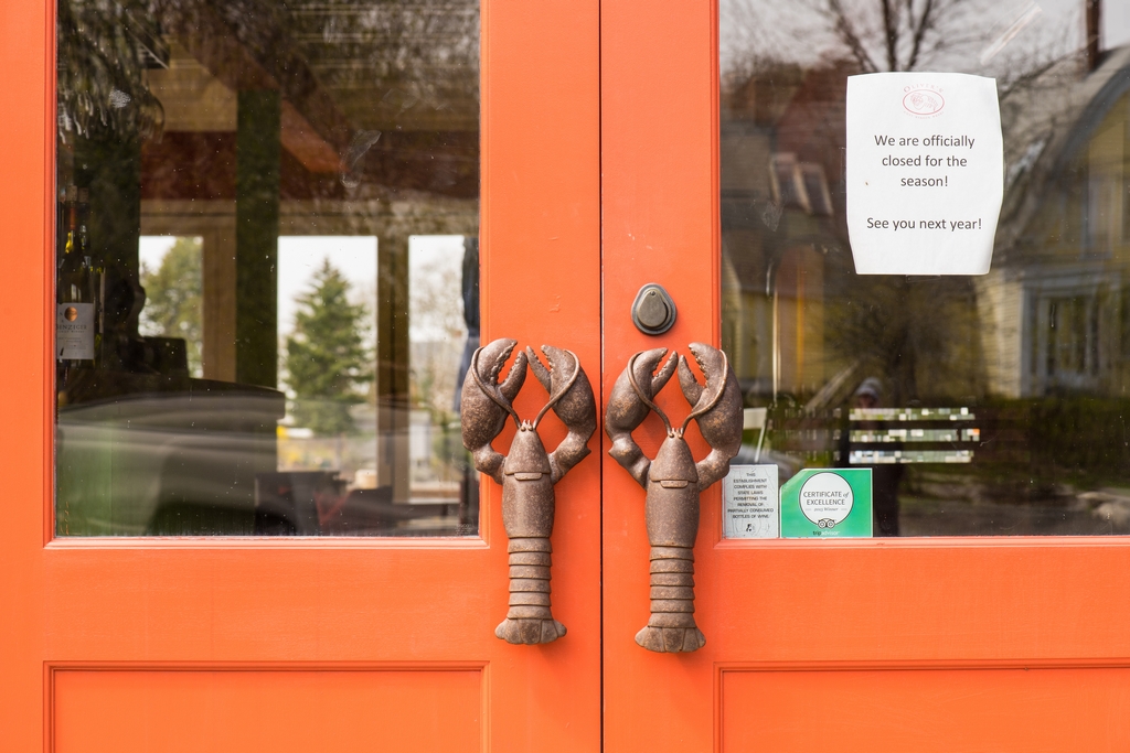Doors with lobster handles and closed for season sign