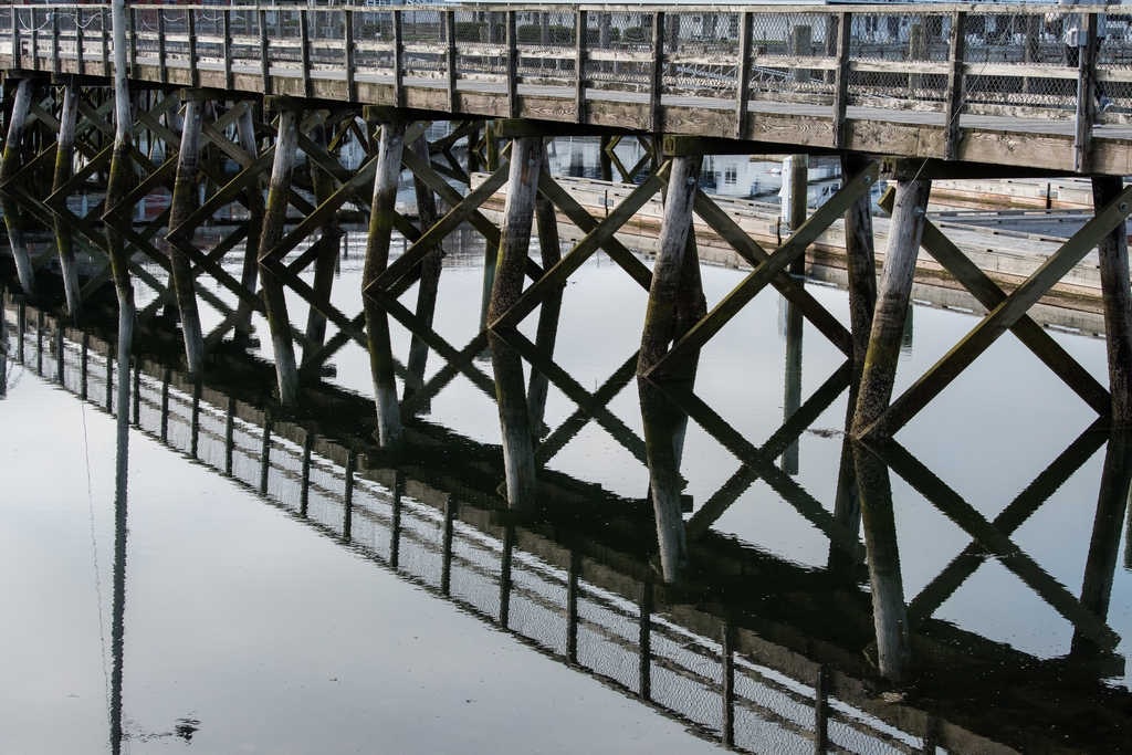 Wooden bridge reflected in water