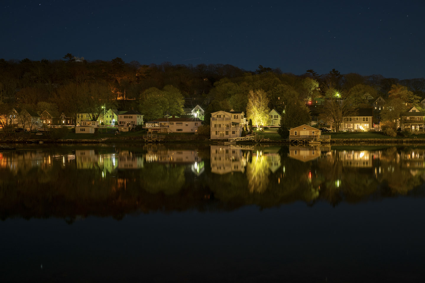Houses on the edge of Boothbay Harbor at night.