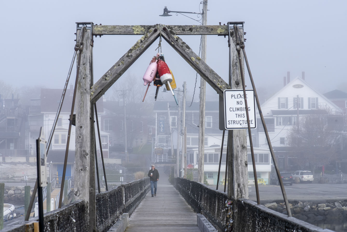 Boothbay Harbor footbridge with a man walking across it