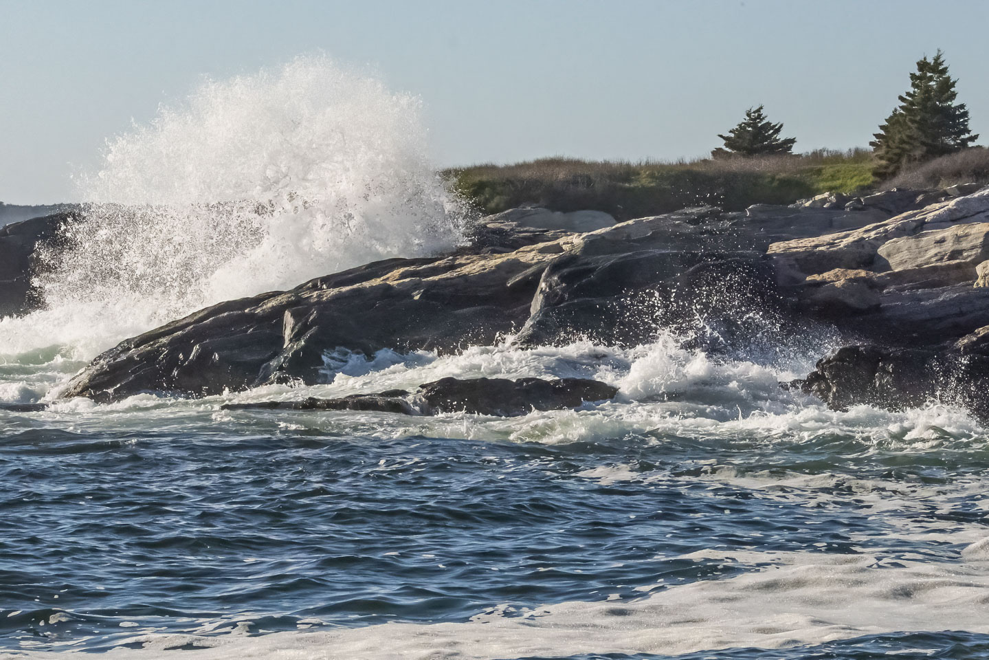A wave crashing against rocks