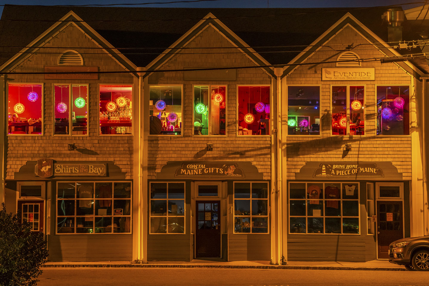 A building in Boothbay Harbor with lights on for nighttime