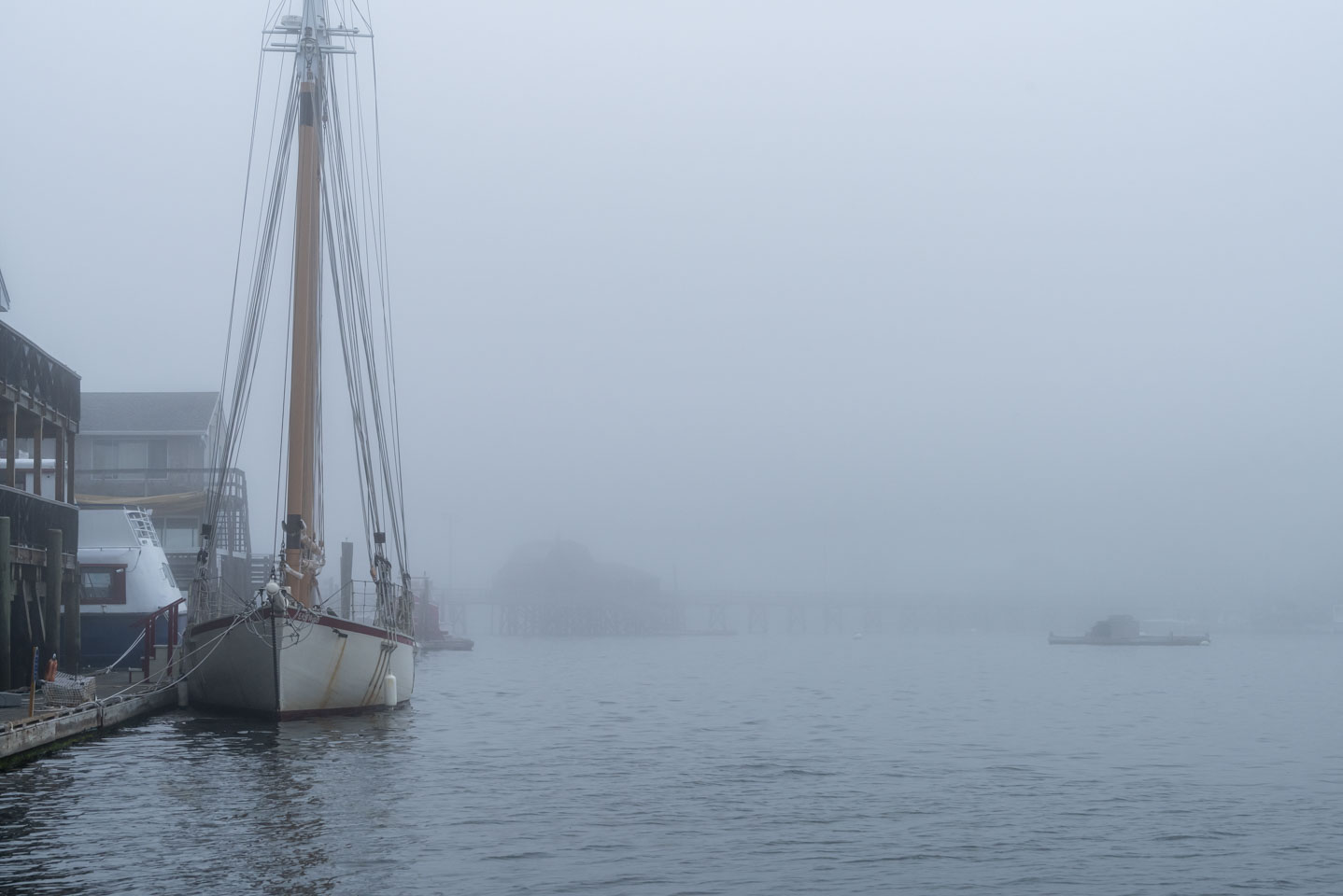 Sailboat in Boothbay Harbor with fog in the background