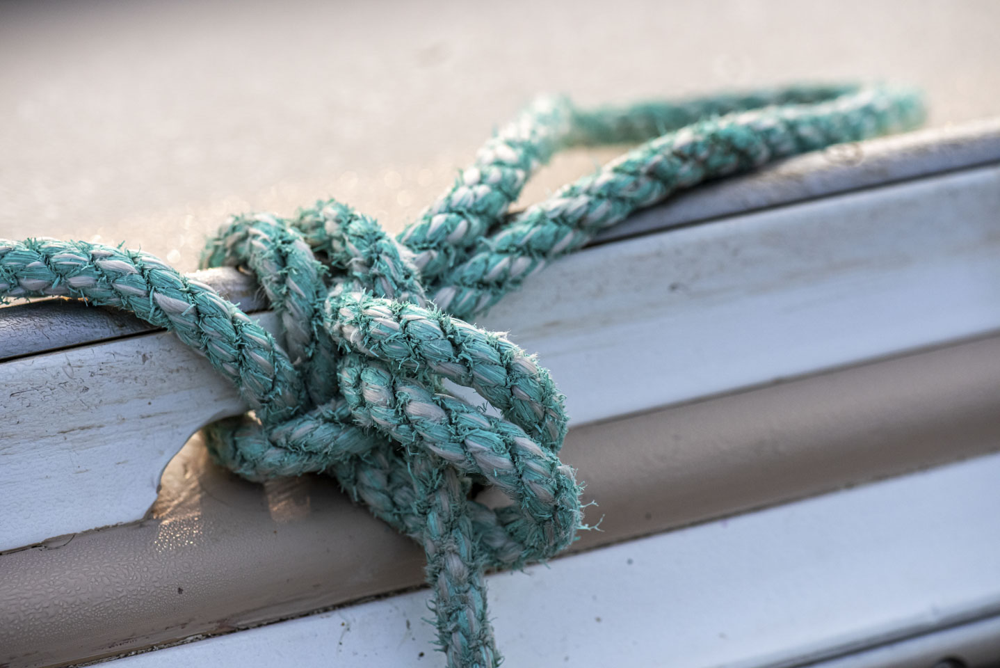 A rope knotted around the edge of a boat