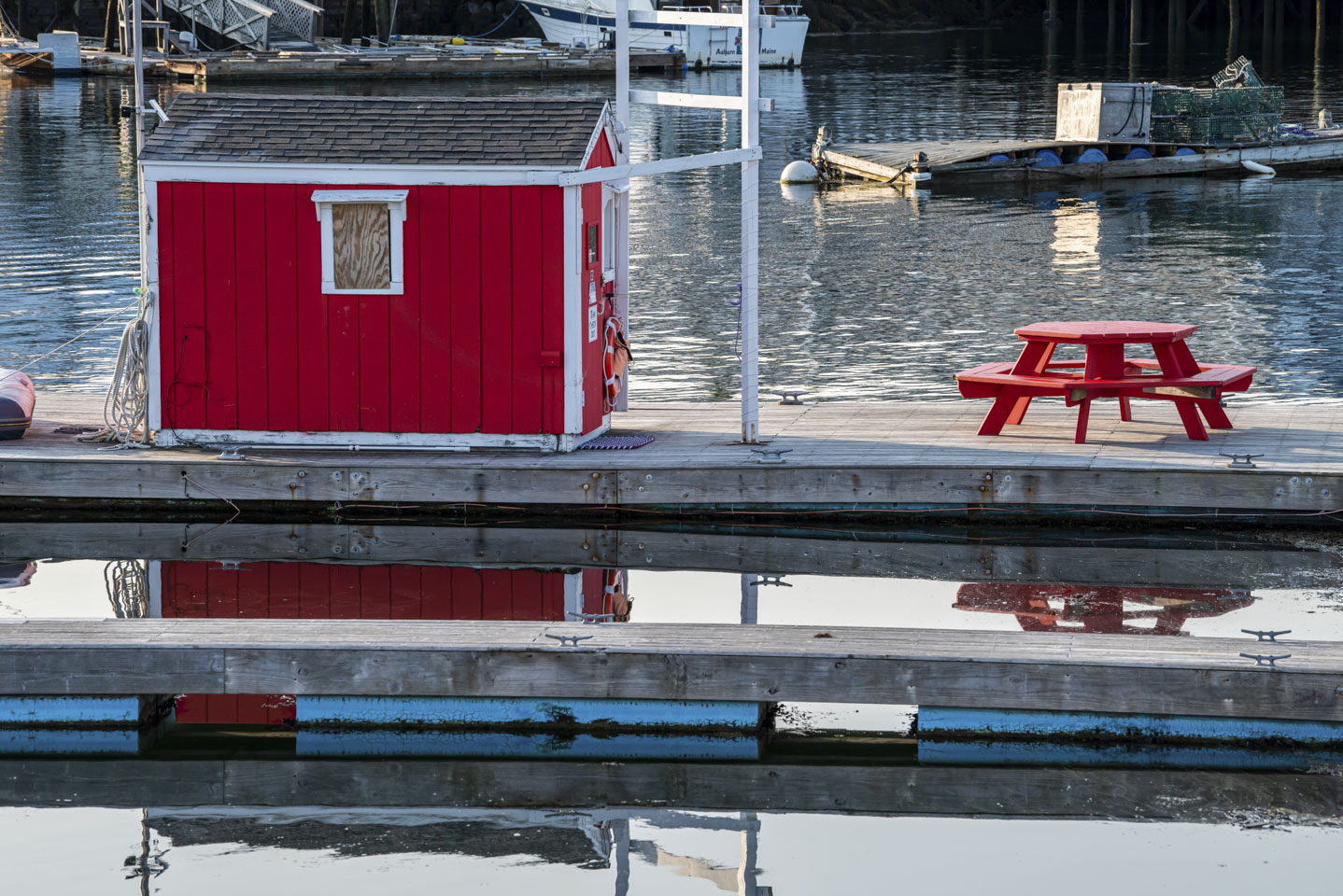 Red shed and red picnic table on a pier