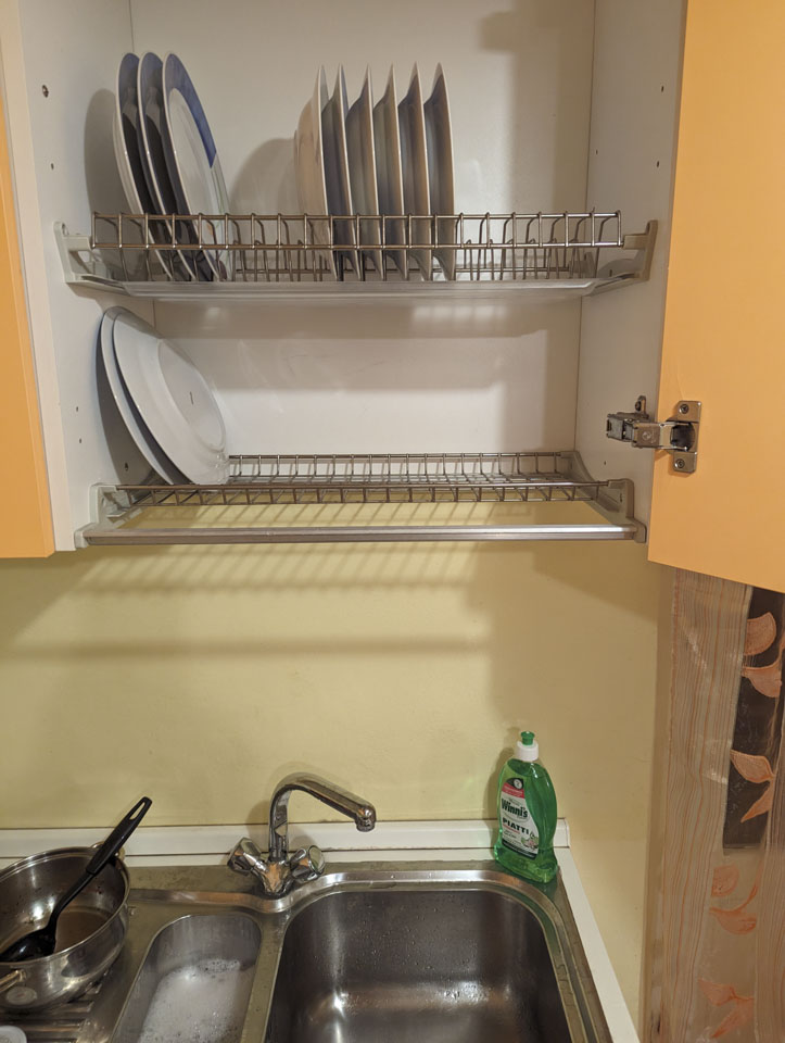 Cupboard with a drying rack inside