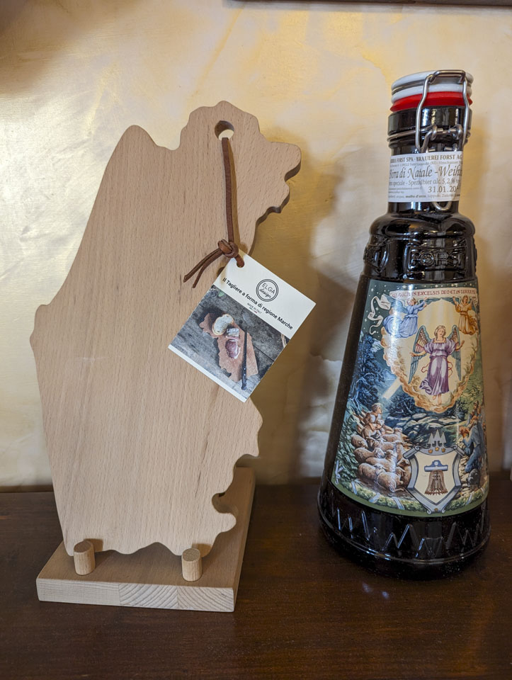 A cutting board in the shape of a region of Italy, and a holiday bottle of beer