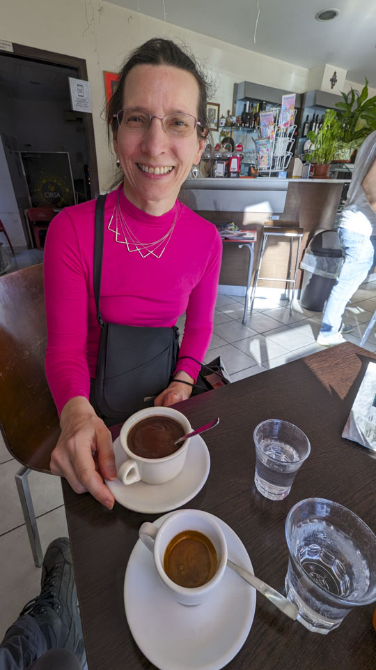 Anne with a cup of ciocolata calda in front of her