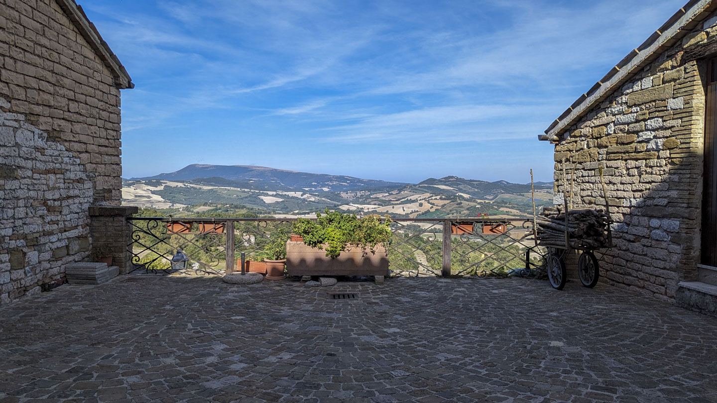 a piazza in Castello with a view of fields and hills