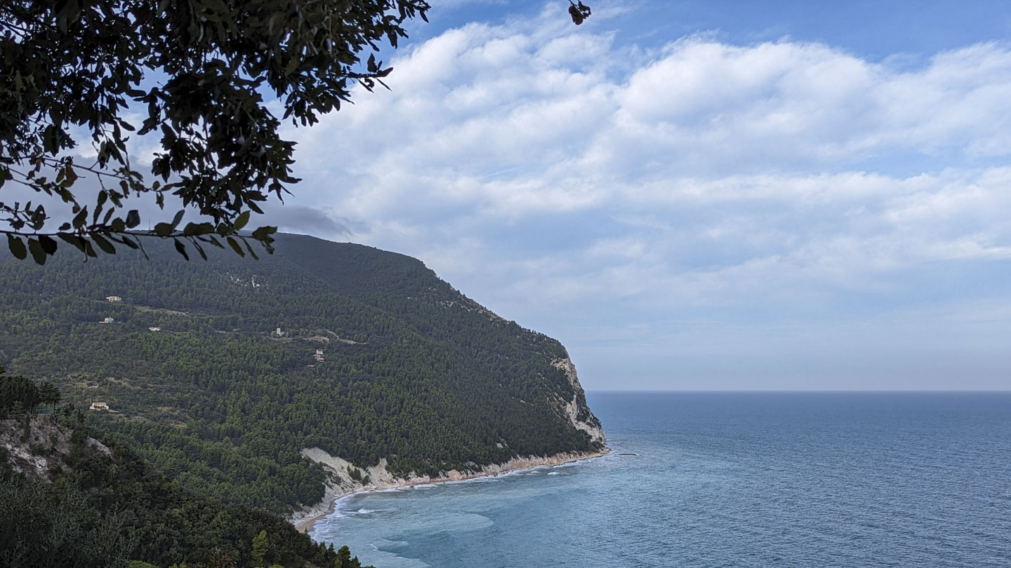 Looking towards the park you see the Adriatic Sea on the left, then extremely steep land going up to Conero Mountain. There are a few scattered buildings amongst the trees on the more gradual southern slope.