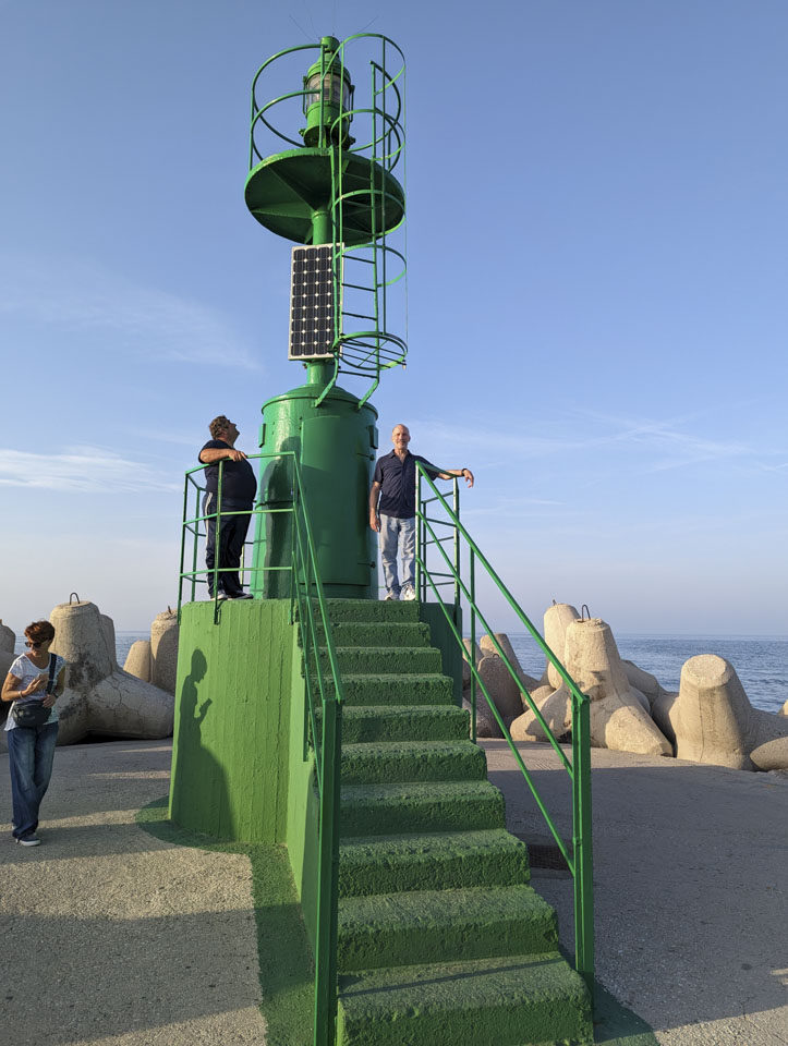 Paul standing on the platform of a green lighthouse