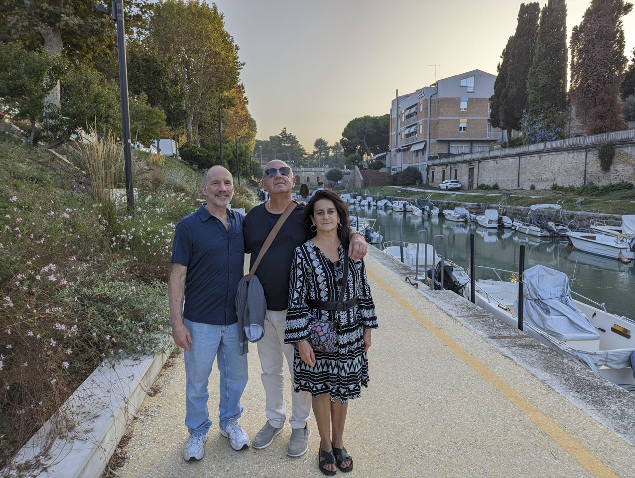 Paul, Francesco, and Doni standing next to the canal