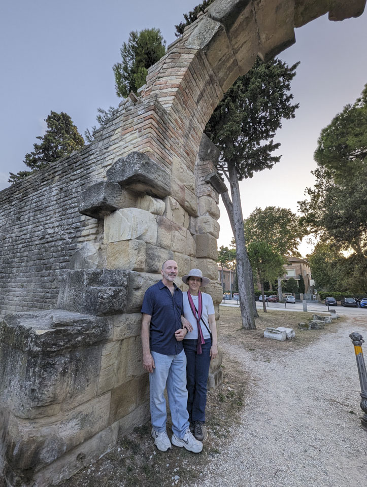Paul and Anne underneath the ruins of an old archway in an ancient wall
