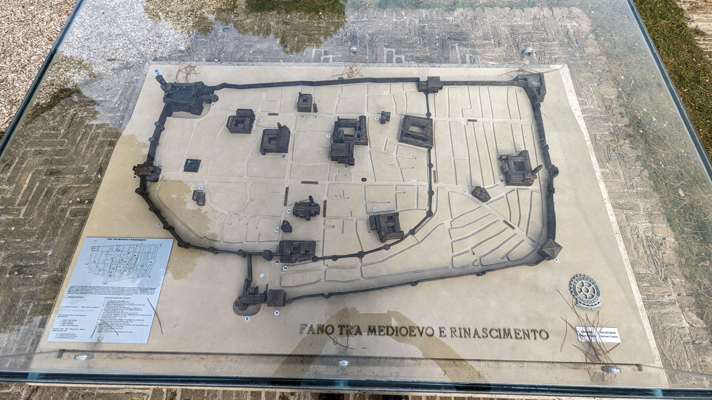 Looking down on a diorama of Medieval Fano. It shows the walls and a large handful of building positions.
