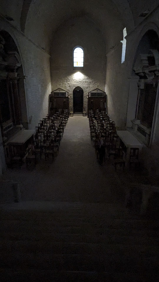 The dark seating area in Fonte Avellana