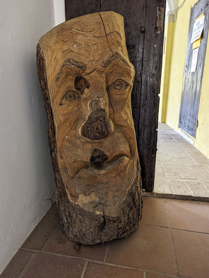 Wood log carved to have a face.