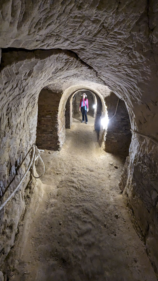 Anne inside a tunnel with side room entrances visible