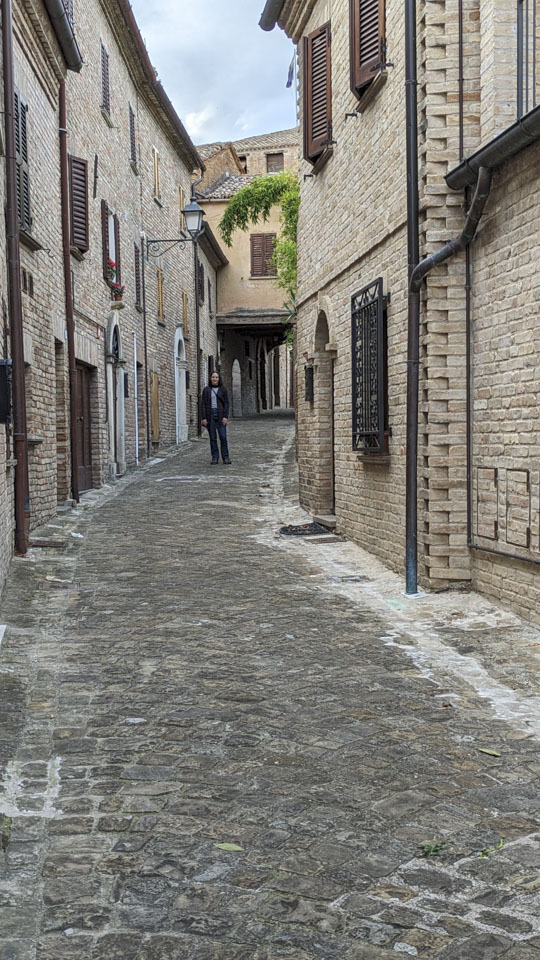Anne standing on a narrow street in Mondavio