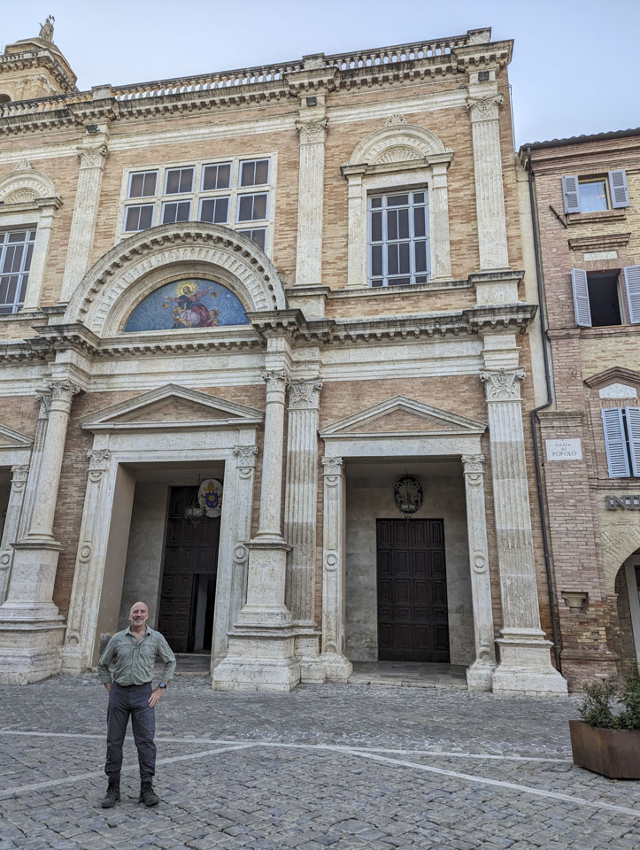 Paul in Offida in front of an ornate old building, the New Collegiate Church, dating from the late 1700s and early 1800s