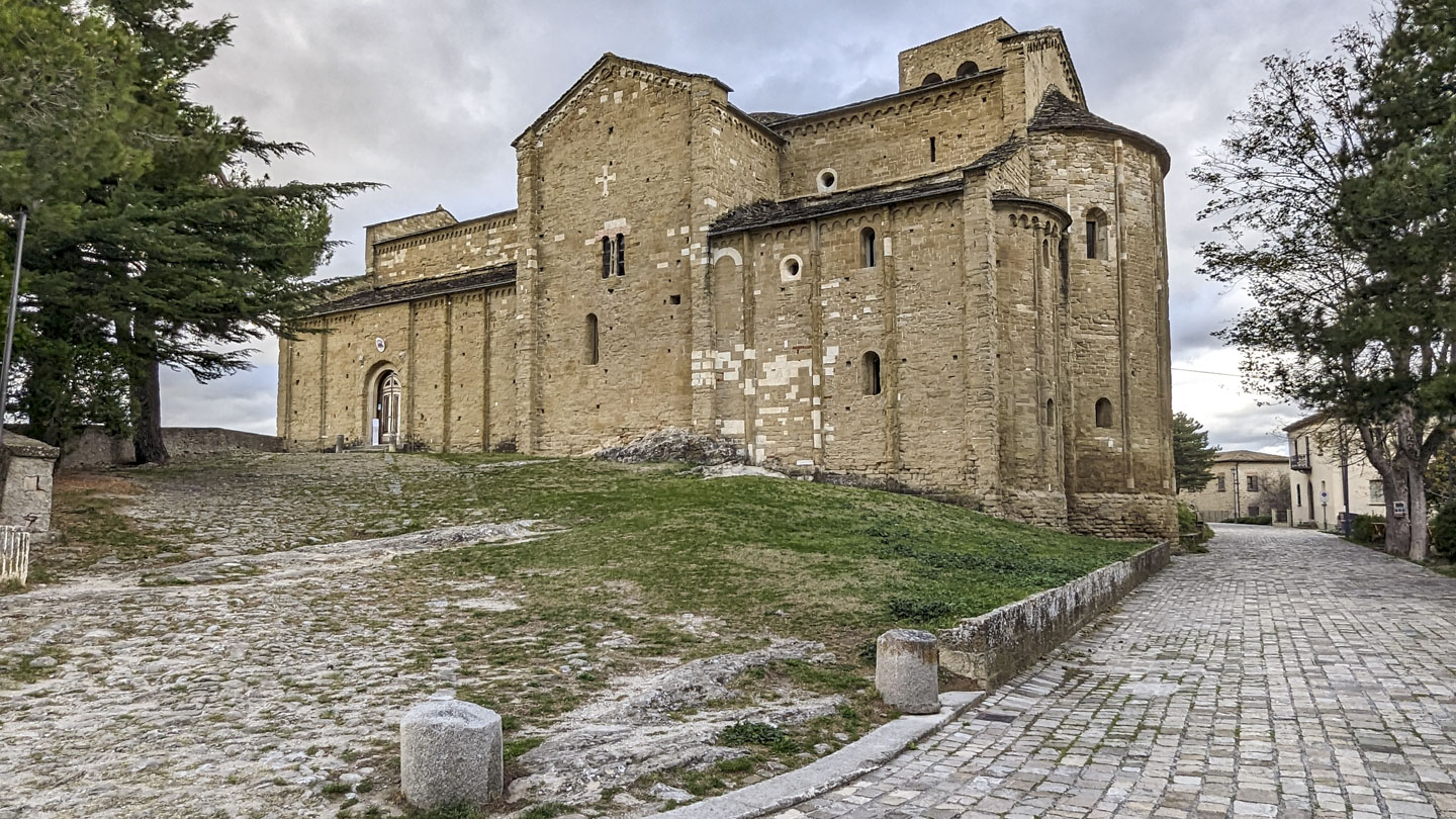 A large stone church, with the entrance on the left end.