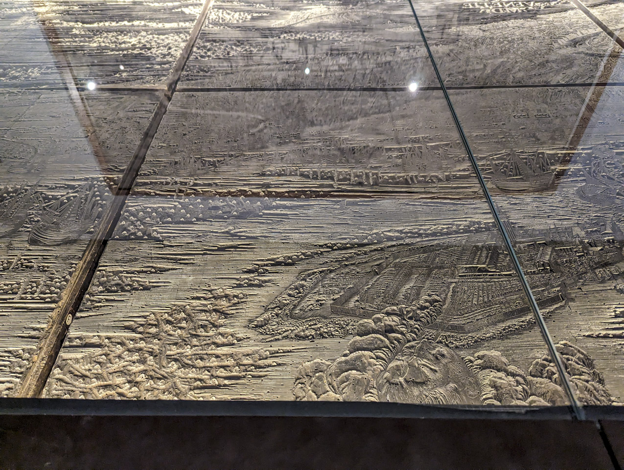 A closer view of one of the edge plates. The face representing one of the winds plus one of the islands are near the viewer.