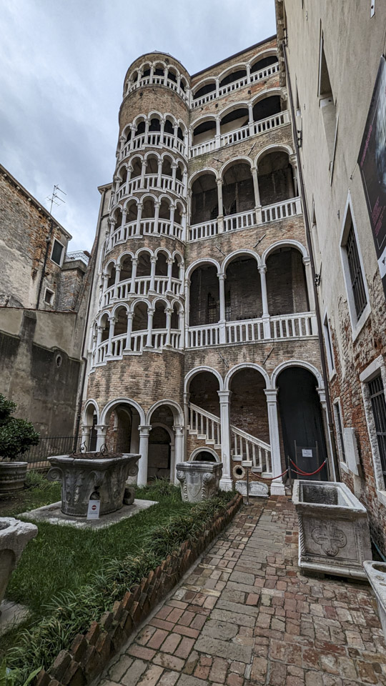 A brick tower with white columns outlining very large viewing areas.