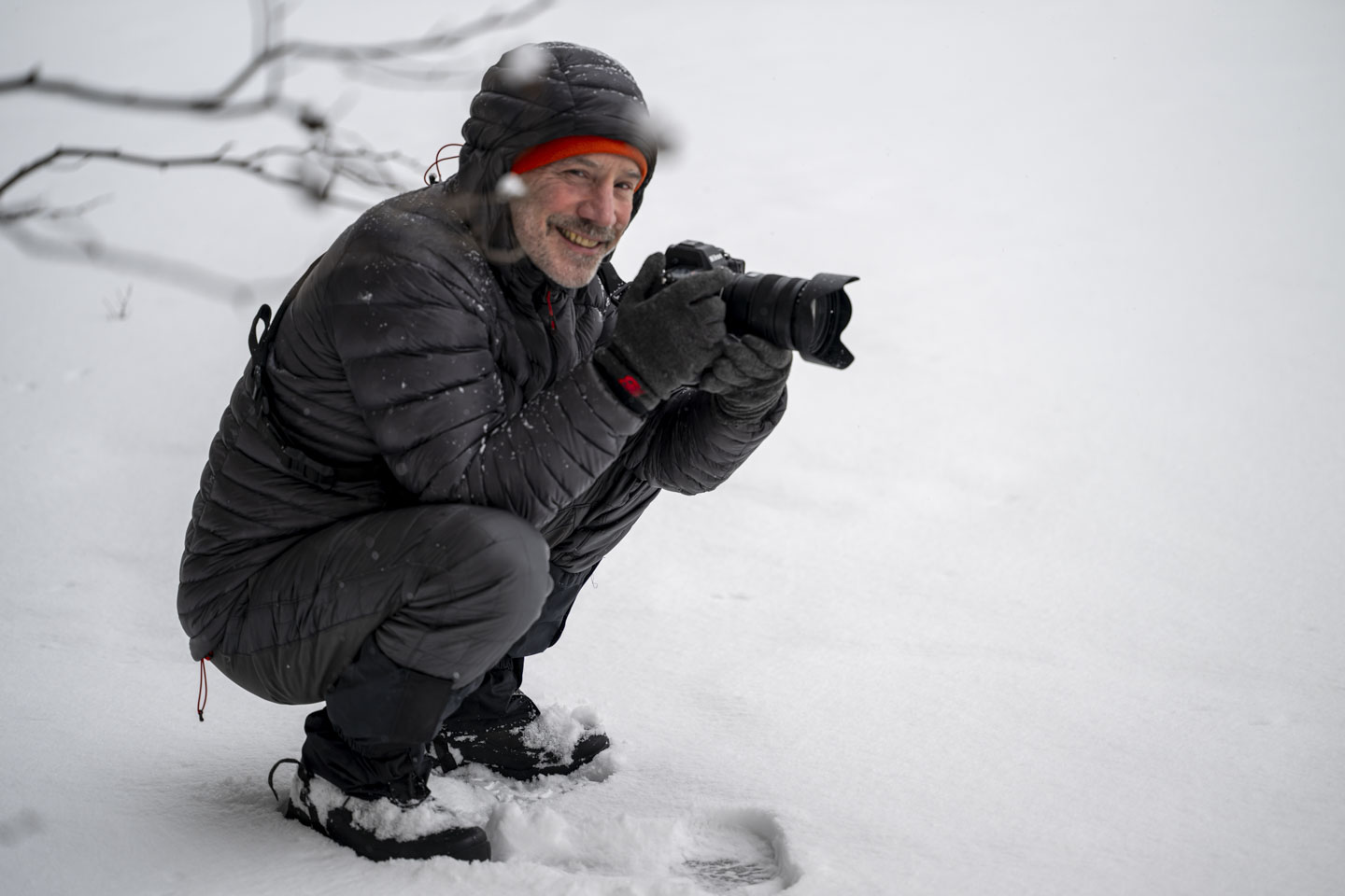 Paul is crouched with his camera.