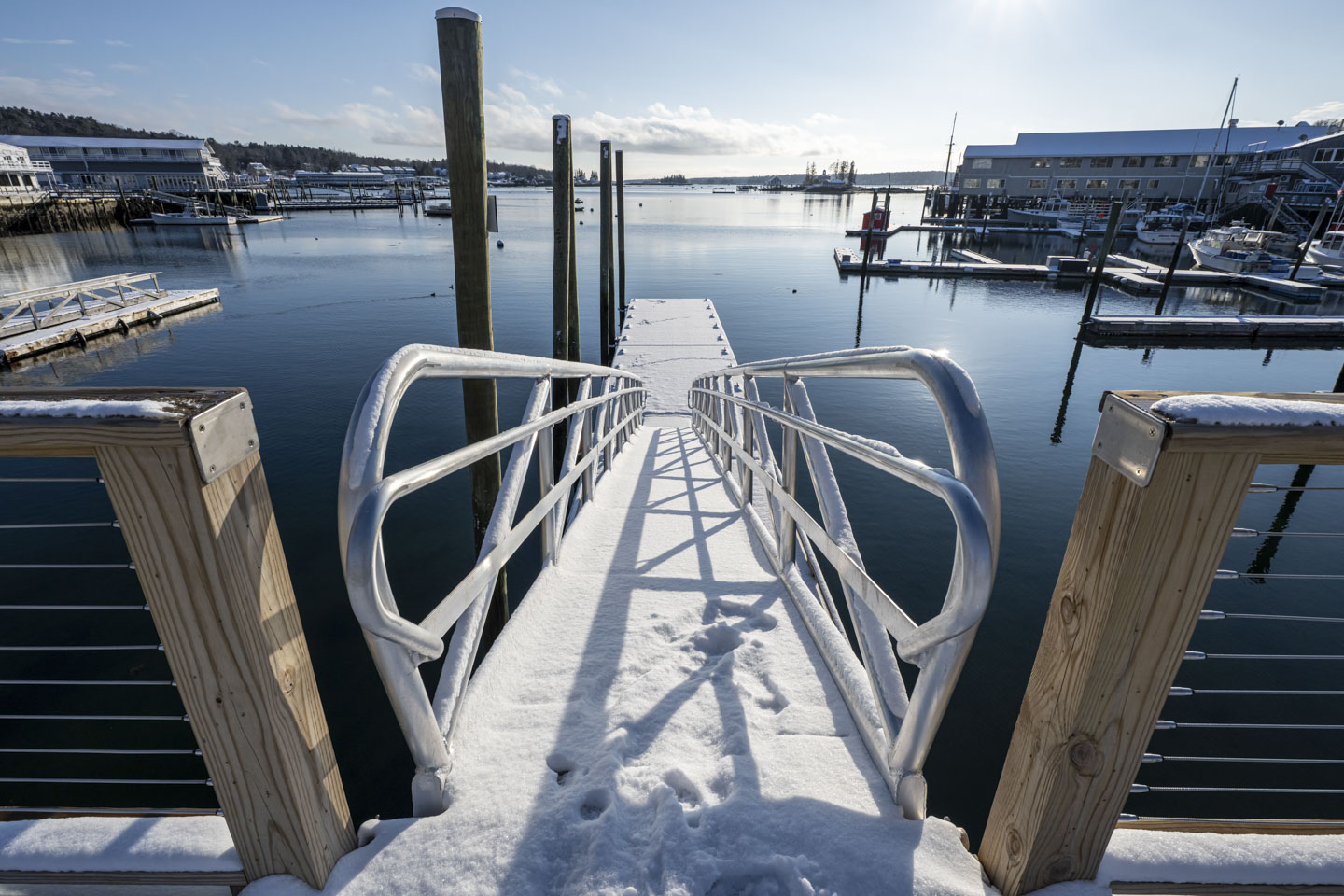 The ramp down to the floating dock is covered with snow. 