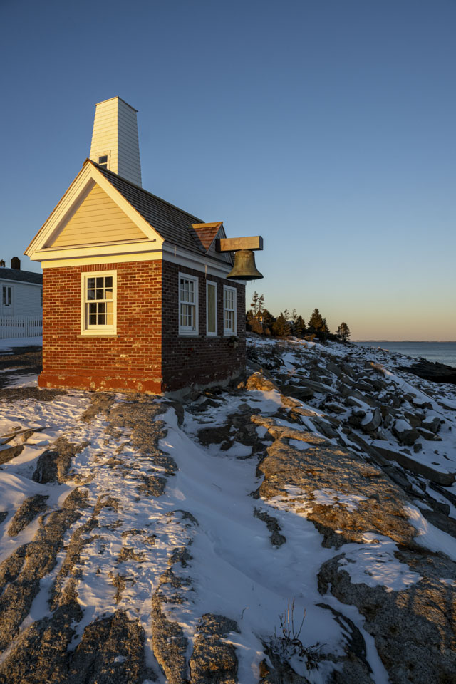 This is another view of the bell house, with snow on the rocks around it.
