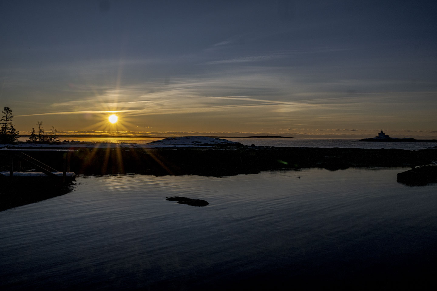 The sun is rising on the left and the outline of Cuckolds can be seen on the right.