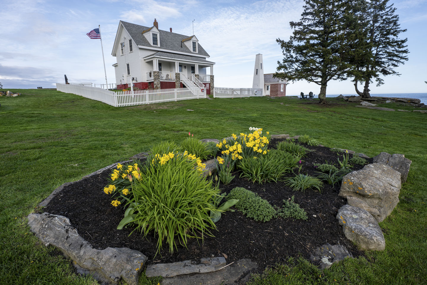 Looking over the flower bed towards Pemaquid Lightkeeper House.