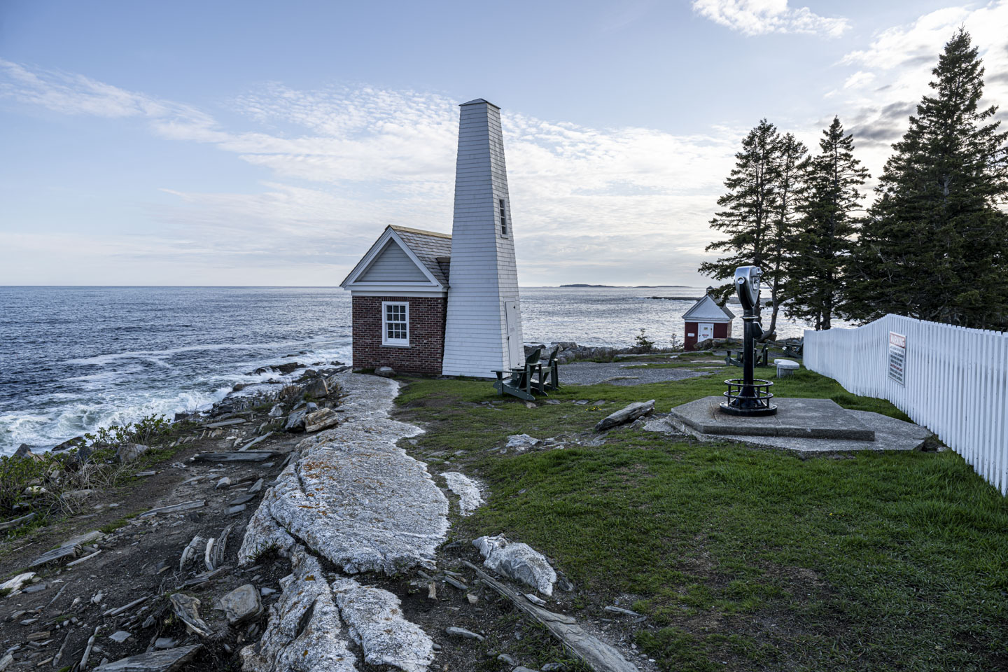 The Fog House stands against the sky and ocean.