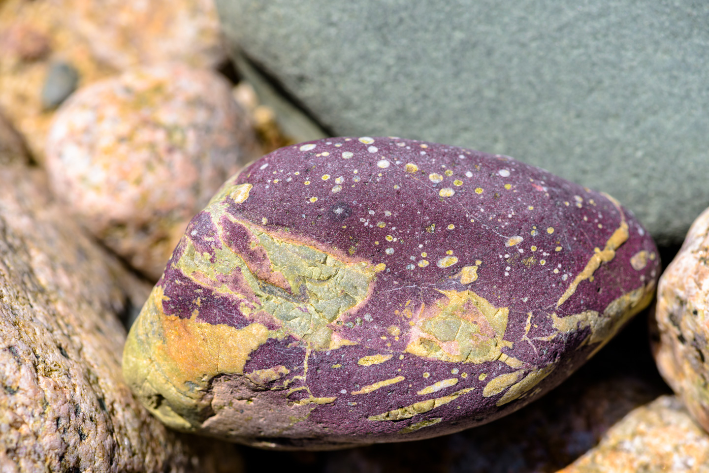 a rock with purple, green and yellow in it