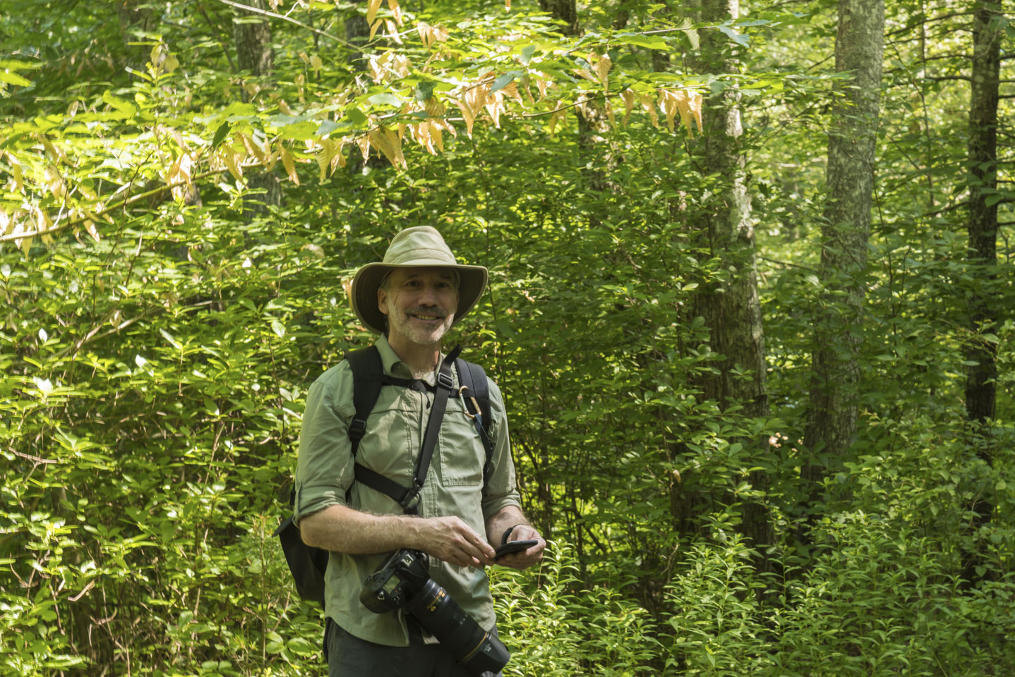 Paul standing in the woods