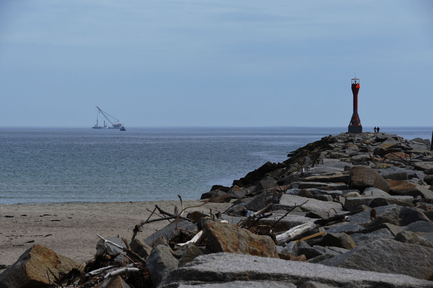 Cape Cod Canal breakwater and a barge with a large crane on it