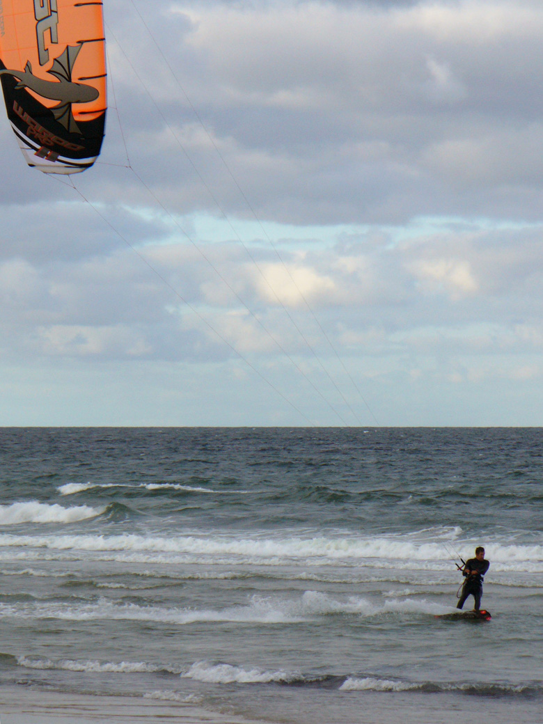 Man in wetsuit windsurfing at Scusset Beach